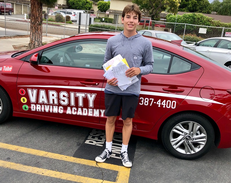 Behind the Wheel Test Orange County Tips and Tricks Male Student Standing Next to Training Vehicle